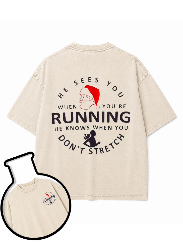 HE SEES YOU WHEN YOU'RE RUNNING HE KNOWS WHEN YOU DON'T STRETCH Washed T-Shirt