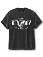 NEVER UNDERESTIMATE AN OLD GUY ON A BICYCLE Washed T-Shirt