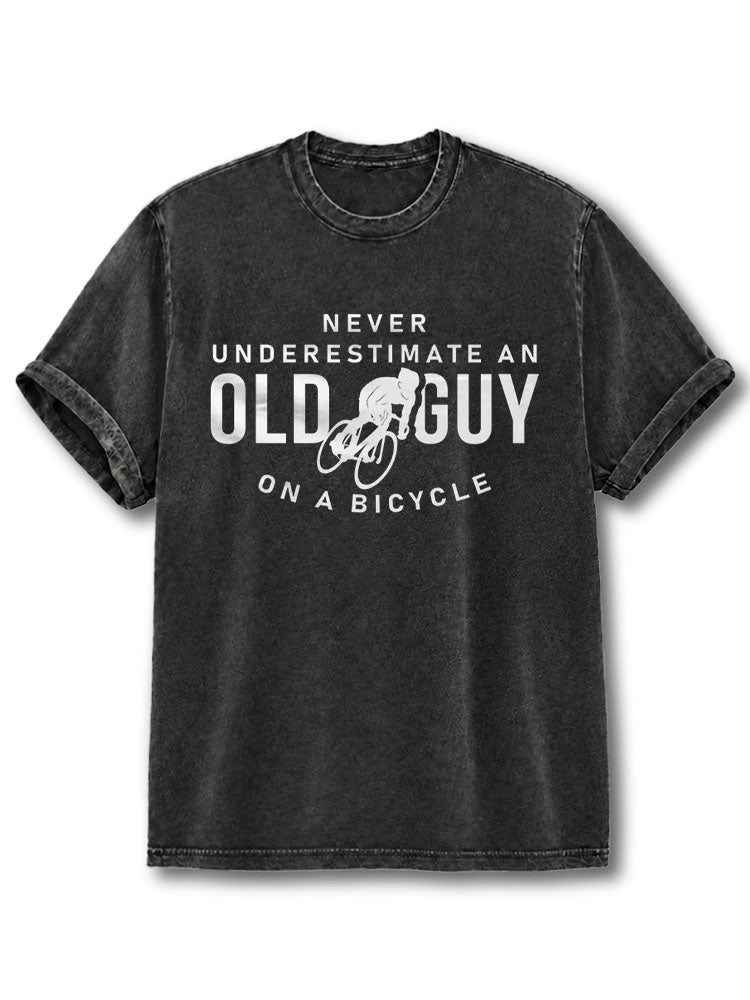 NEVER UNDERESTIMATE AN OLD GUY ON A BICYCLE Washed T-Shirt