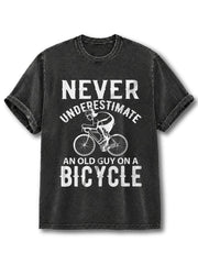 NEVER UNDERESTIMATE AN OLD GUY ON A BICYCLE Washed T-Shirt