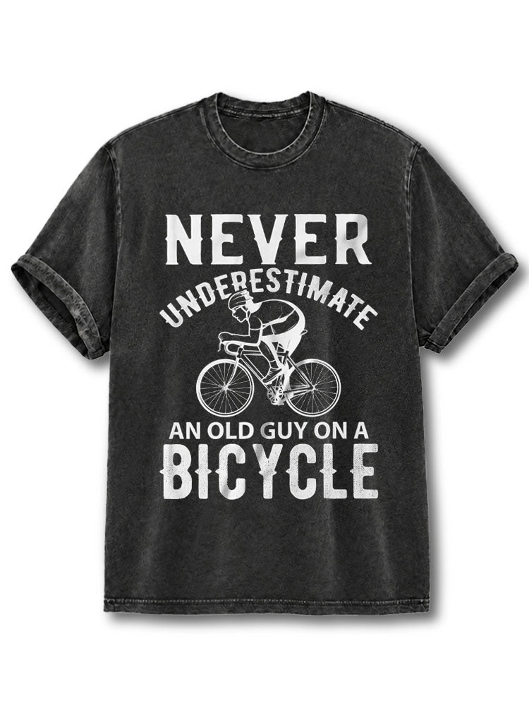 NEVER UNDERESTIMATE AN OLD GUY ON A BICYCLE Washed T-Shirt